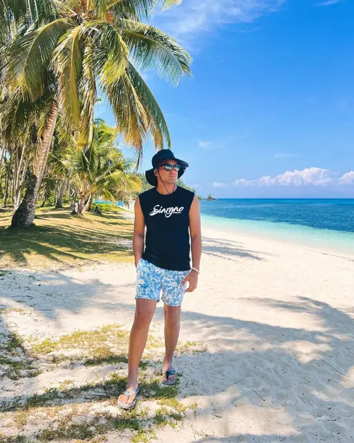 Merald on a white-sand beach in Siargao