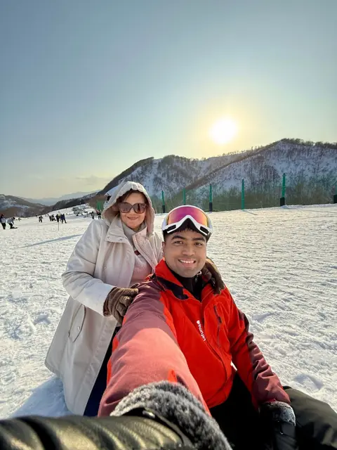 Merald taking a selfie on a snowy mountain slope