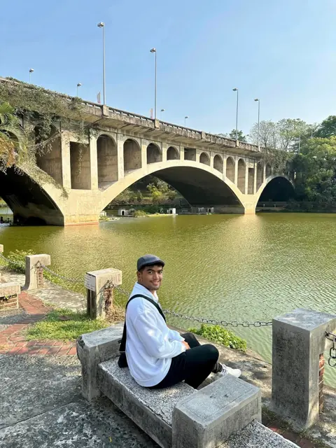Merald by a stone arch bridge in Taiwan