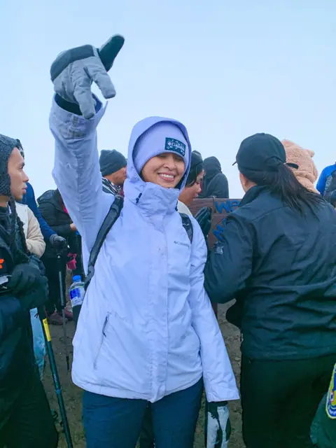 Mirjan celebrating with fellow hikers on Mount Pulag