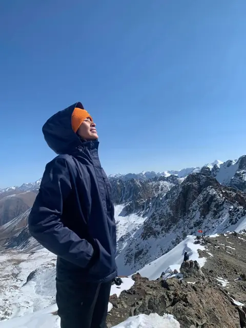 Mirjan looking out over snow-covered mountain peaks